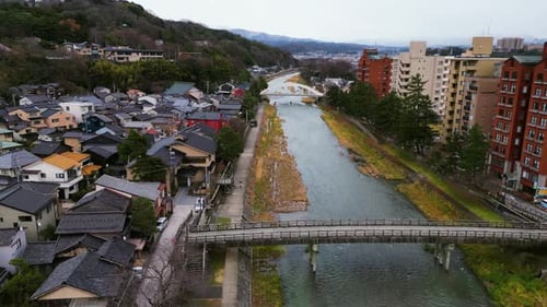 Drone following the Asanogawa River ihrough Kanazawa city, autumn in Japan