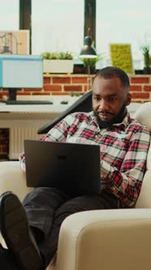 Teleworker Checking His Emails on Laptop