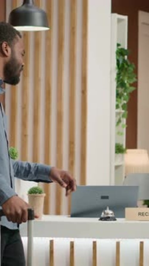 Guest Rings Bell at Hotel Reception Desk