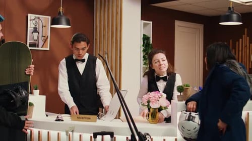 Hotel Receptionists Assist Ski Vacation Customers