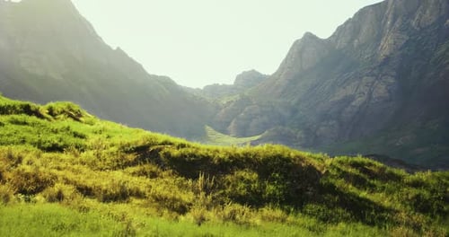 Beautiful Mountain Landscape with Lush Green Grass and Sunlight