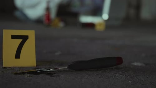 Crime Scene Evidence with Knife and Marker
