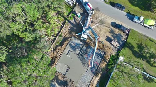 Aerial View of Workers at New House Construction Site Pouring Concrete of Flat Slab Foundation