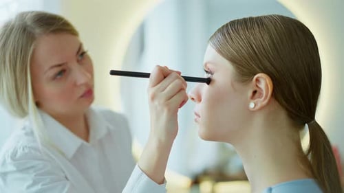 Makeup Artist Work in Her Beauty Studio Portrait of Woman Applying By Professional Make Up Master