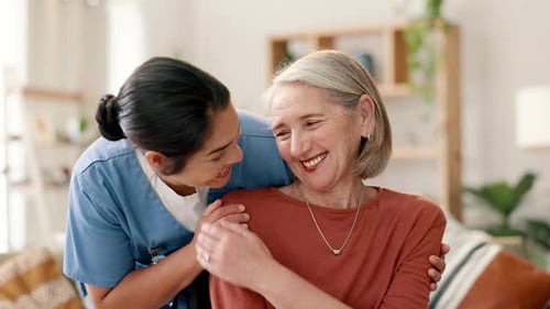 Woman Hugging Senior Woman Indoors