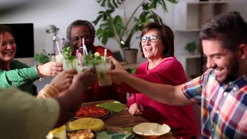 Happy friends group cheering mojito drinks at fancy bar restaurant - Young people having fun toastin