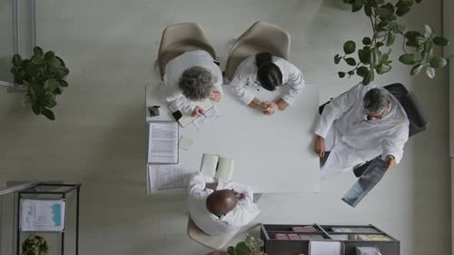 Top View of Diverse Doctors Examining Patient Xray in Office