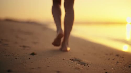 Slim Fit Legs of Woman Tourist Barefooted Feet Walking on Sandy Ocean Beach in Luxury Resort at
