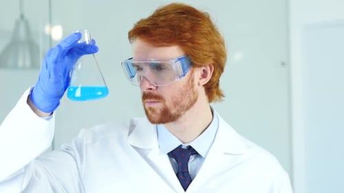 Scientist Holding Flask with Blue Liquid in Lab