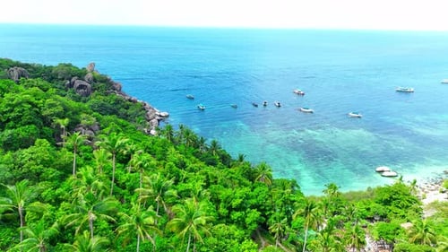 Sandy beach shore with beautiful resort surrounded by clear sea water.