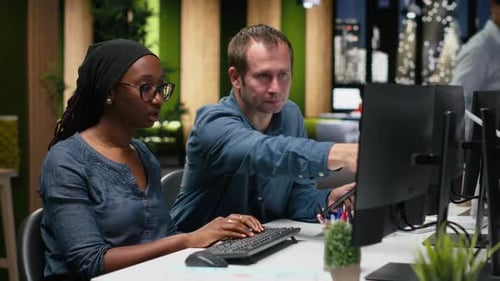Team Collaborating on a Computer in a Modern Office