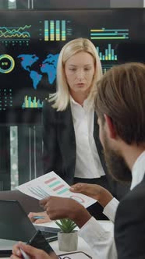 Businesswoman Presenting Data in Modern Boardroom Meeting