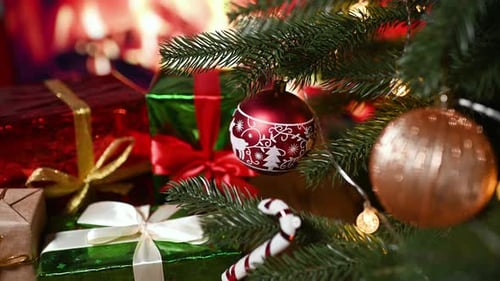 Christmas Toys and New Year's Gifts Against the Background of a Burning Cozy Fireplace and a