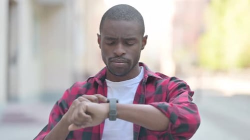 Young Adult Using Smart Watch Device