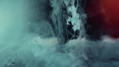 Colorful Red,Blue Paint Drops Mixing In Water. Ink Swirling Underwater. CLose up