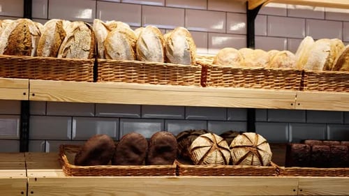 Freshly baked bread laid out in baskets on the bakery counter
