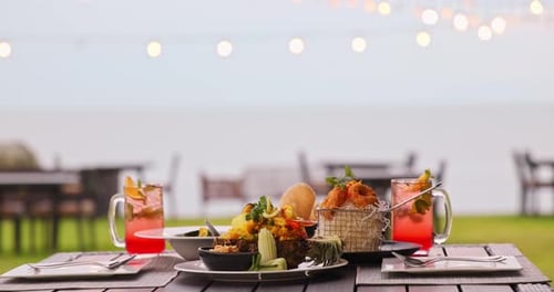 Thai seafood dinner served on outdoor table at beach resort