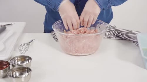 Step By Step Mixing Ingredients for a Classic Beef Meatloaf Recipe in a Glass Mixing Bowl