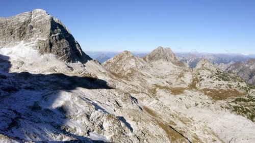 drone view of a valley in the alps mountains covered by snow