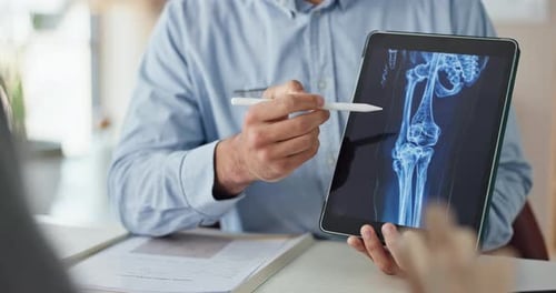 Doctor explaining X-Ray results with digital tablet