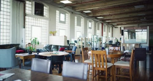 Empty modern office space with high ceilings and wood floors daytime wide shot
