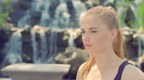 Thoughtful Woman Portrait Near Waterfall. Closeup of Model Posing at Nature. Blonde