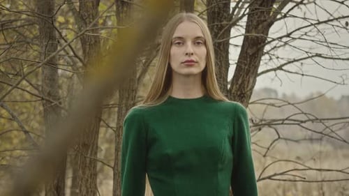Model posing for photoshoot in autumn forest