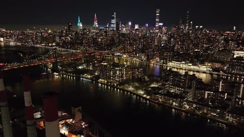 Aerial Views Highlight Glowing New York City Skyline and East River at Night Showcasing the Iconic