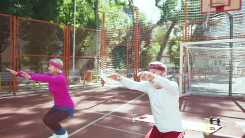 Senior Couple Exercising Together on an Outdoor Court