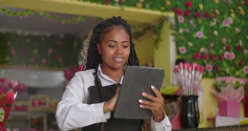 Woman Working at Flower Shop Using a Tablet