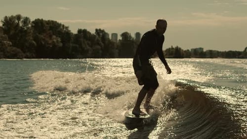 Man wake surfing on a sunny day in the city