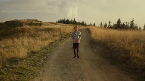 Man Running on a Mountain Trail at Sunset