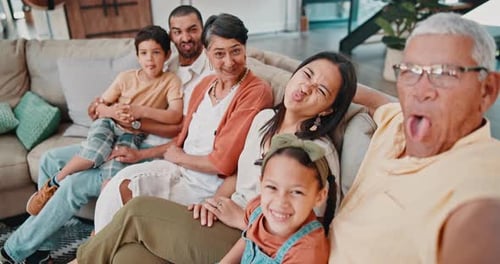 Happy Multigenerational Family Poses on Couch at Home