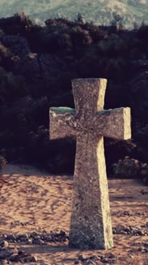 A Solitary Cross Standing Tall Amidst a Barren Desert Landscape