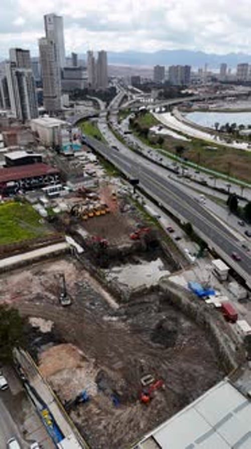 Aerial Drone View of Excavators and Trucks Working at Construction Site