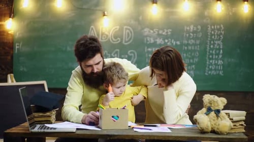 Parents and Child Drawing at Table