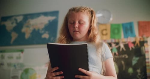 Primary School Girl Speaking Showcasing Knowledge of Geography in Front of Classmates and Teacher