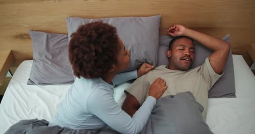 Above, wake up and couple in bed with snoring, loud sound or nasal congestion in home