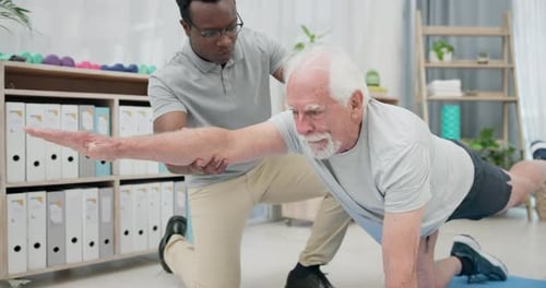 Senior Man Stretching Arm During Physical Therapy
