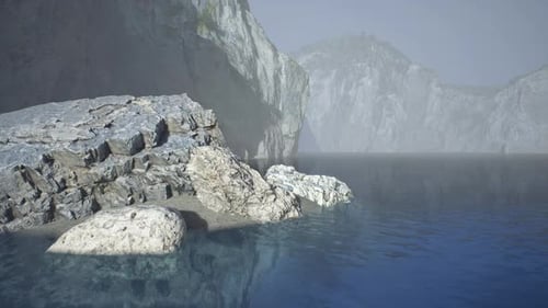 Serene Coastal View of Rocky Shoreline and Tranquil Waters in Spain at Dusk