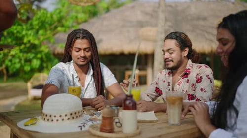 LGBTQ Friends Gather Enjoy Drinks at Outdoor Cafe Diverse Group Laughs Shares Stories Under Thatched