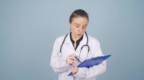 The doctor examining the paperwork is thoughtful.
