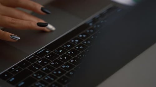 African american woman uses touchpad laptop computer in cafe for remote work