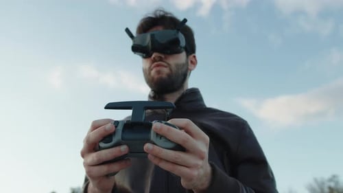 Man Controls Drone With Remote and Goggles