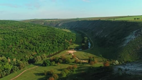 Scenic Countryside Vista Sunlit Landscape Featuring Winding Waterway And Lush Forests