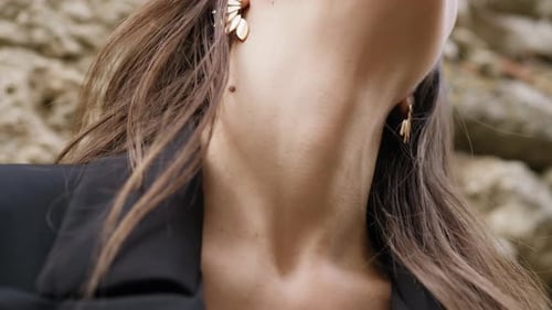 Woman Posing with Elegant Gold Earrings