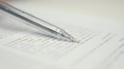 Close-up: woman lawyer office worker proofreading a contract before signing