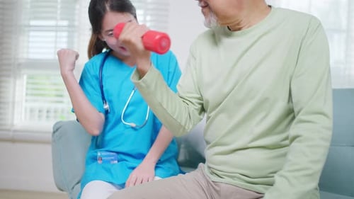 Elderly Man Exercising With Physical Therapist at Home