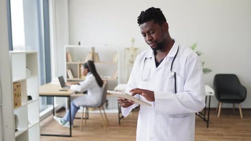 Medical Professional Using Tablet, Gives Thumbs Up Approval