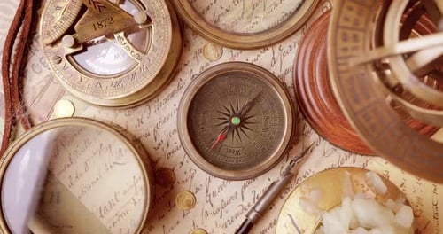 Vintage style travel and adventure. Vintage old compass and other vintage items on the table.